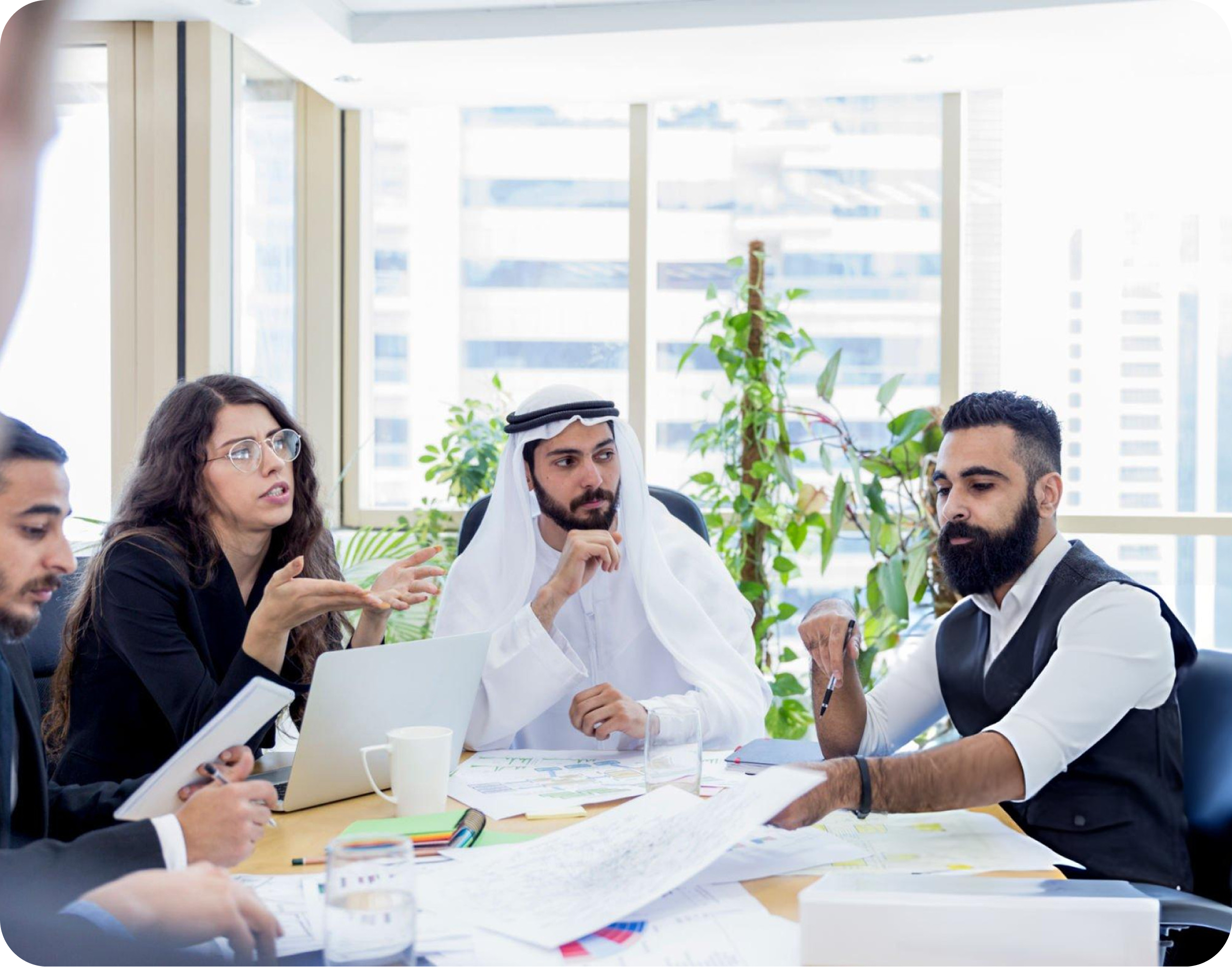 Team meeting in progress with professionals discussing ideas around a conference table